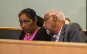 Amandeep Kaur (left) sitting in the dock at the Auckland High Court with a translator (right).
