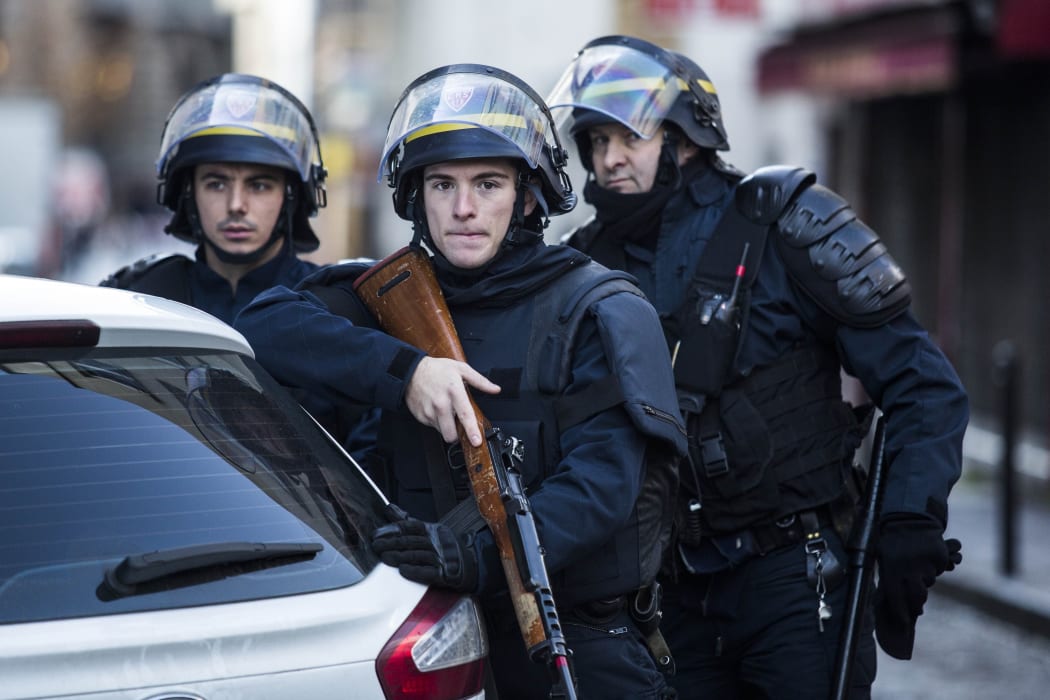 Armed police stand guard after  knife-wielding man was shot dead on the anniversary of the Charlie Hebdo attacks.
