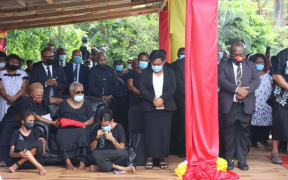 Lady Veronica Somare (seated in chair), along with family members and dignitiaries including PNG Prime Minister James Marape (standing on the right) attend the final burial of Sir Michael Somare in Wewak.