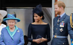 Queen Elizabeth II, Meghan, Duchess of Sussex, Prince Harry, Duke of Sussex stand on the balcony of Buckingham Palace on July 10, 2018.