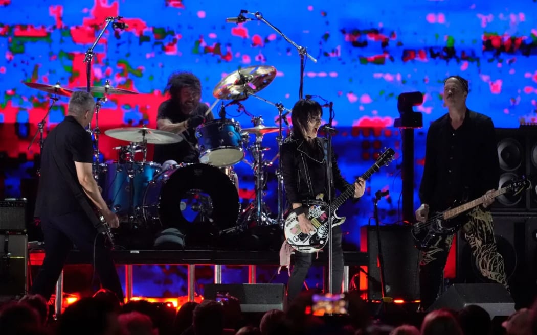 Joan Jett, second from right, performs with (from left) Pat Smear, Dave Grohl, and Krist Novoselic of Nirvana during the FireAid benefit concert at The Forum in Inglewood.