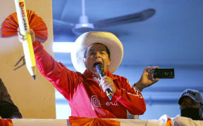 Peruvian leftist presidential candidate for Peru Libre party Pedro Castillo delivers a speech to supporters from a balcony at his campaign headquarters during his closing rally in Lima.