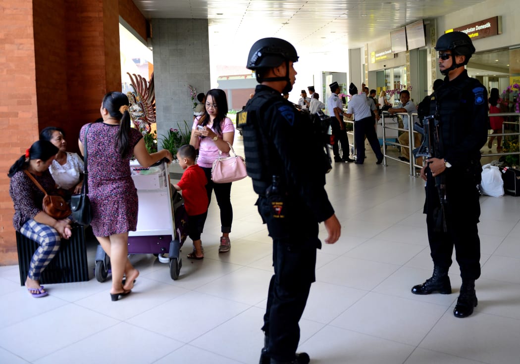 Indonesian Special Police patrol at Ngurah Rai Airport in Bali one day after a deadly attack reportedly orchestrated by Islamic State.