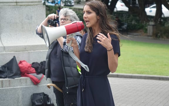 Golriz Ghahraman addresses the rally, Edwina Hughes takes pictures.