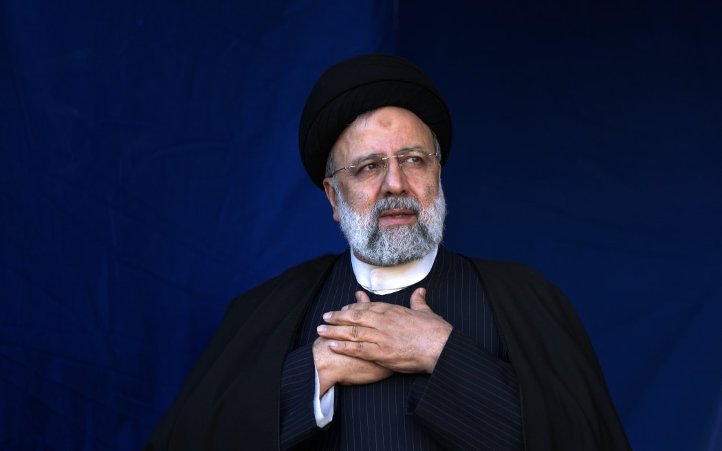FILE- Iranian President Ebrahim Raisi places his hands on his heart as a gesture of respect to the crowd during the funeral ceremony of the victims of Wednesday's bomb explosion in the city of Kerman about 510 miles (820 kms) southeast of the capital Tehran, Iran, Jan. 5, 2024.
