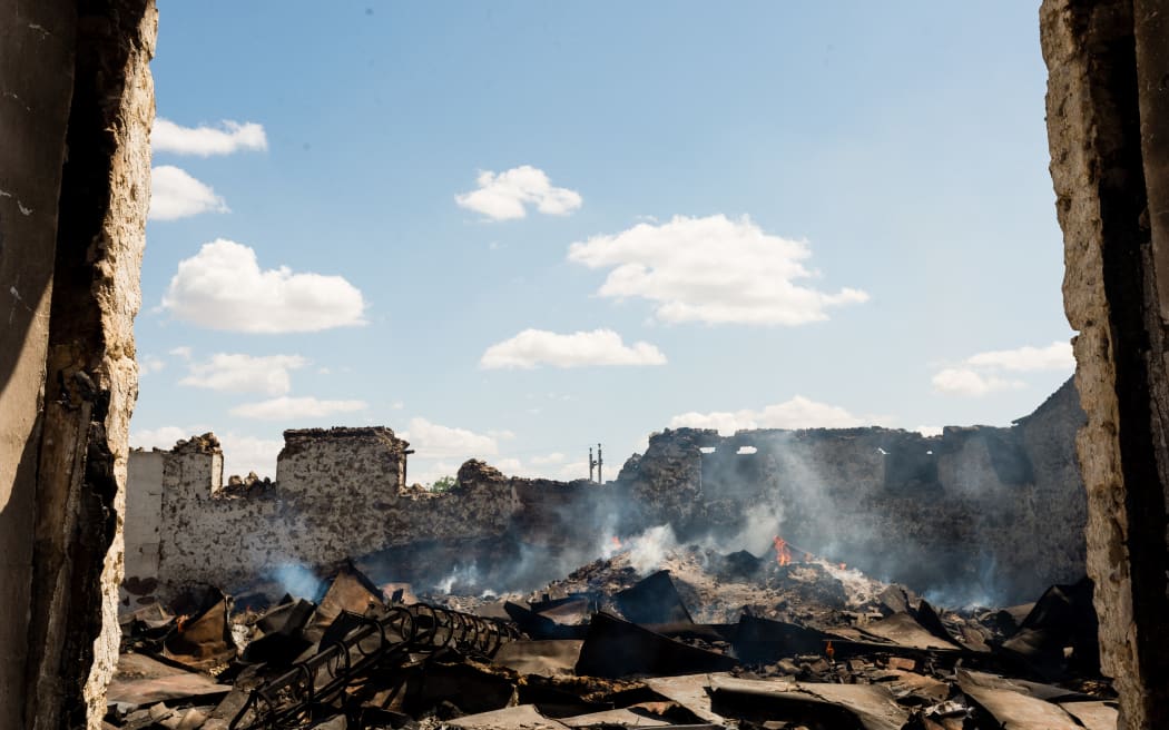 Wheat grain at a storage warehouse five kilometres from Russian forces in the Kherson region continues to burn three weeks after the site was shelled in Mykolaiv, Ukraine, 22 July 2022.