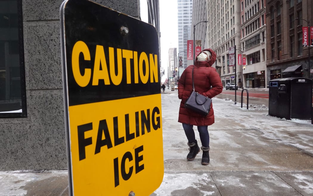 CHICAGO, ILLINOIS - DECEMBER 23: A pedestrian walks through downtown as temperatures hover in the negative single-digits on December 23, 2022 in Chicago, Illinois. Sub-zero temperatures are expected to grip the city for the next couple of days with wind chill temperature dipping as low as -40 degrees.   Scott Olson/Getty Images/AFP (Photo by SCOTT OLSON / GETTY IMAGES NORTH AMERICA / Getty Images via AFP)