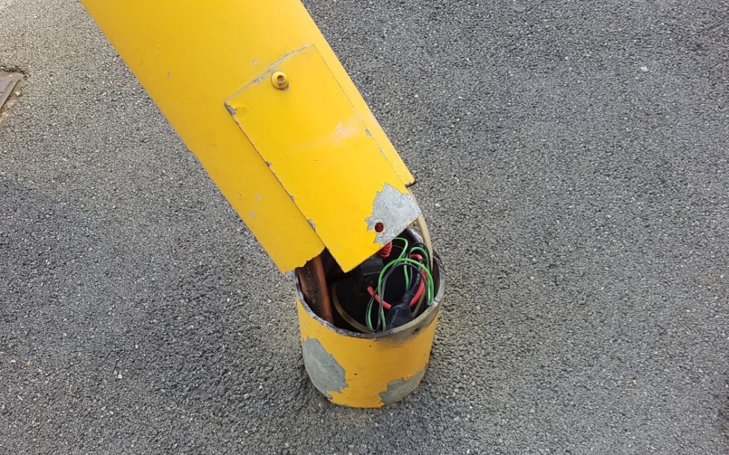The base of the pole which was supporting the toppled traffic light.