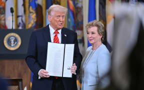 US President Donald Trump holds an executive order after signing it alongside US Secretary of Education Linda McMahon (R) during an education event in the East Room of the White house in Washington, DC, March 20, 2025. President Donald Trump signed an order aimed at shutting down the Department of Education, a decades-long goal on the US right that objects to federal involvement in school systems run by individual states. By law, the Education Department -- created in 1979 -- cannot be shuttered without the approval of Congress, and Republicans do not have the votes to push that through. (Photo by ROBERTO SCHMIDT / AFP)