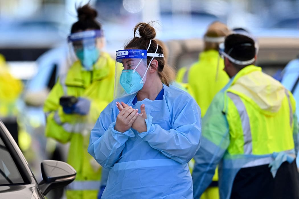 Health workers conduct Covid-19 tests at the St. Vincents Hospital drive-through testing clinic at Bondi Beach in Sydney 27 June, 2021.
