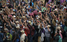 Honduran migrants, part of a caravan heading to the United States, gather to pray in Vado Hondo, Guatemala on January 17, 2021.