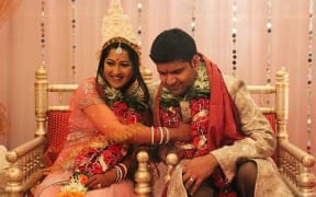 Ishita and Zorran laughing during their Hindu wedding ceremony.