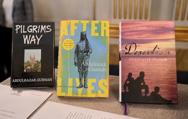 Books by Tanzanian-born novelist Abdulrazak Gurnah are on display at the Swedish Academy in Stockholm after the author was announced as the winner of the 2021 Nobel Prize in Literature, on October 7, 2021. Tanzanian-born novelist Abdulrazak Gurnah won the Nobel Literature Prize, the Swedish Academy said. Gurnah, who grew up on the island of Zanzibar, but who arrived in England as a refugee at the end of the 1960s, was honoured "for his uncompromising and compassionate penetration of the effects of colonialism and the fate of the refugee in the gulf between cultures and continents."