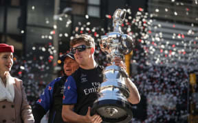 Peter Burling holds the America's Cup during the Wellington victory parade.