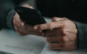 A man uses a cell phone.