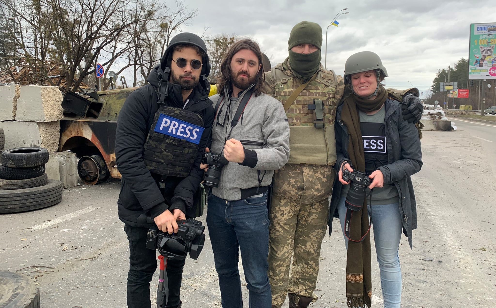 Kiwi photojournalist Tom Mutch (second from left) with fellow journalists and Ukraine soldier