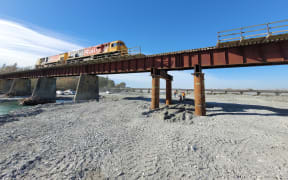A train crossing the Rangitata Rail Bridge on 25 April, 2024, during testing following repairs made after flooding washed away a pier and left the bridge sagging.