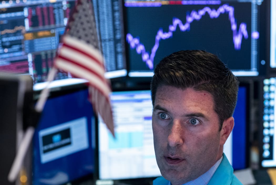 Traders work after the closing bell at the New York Stock Exchange (NYSE).