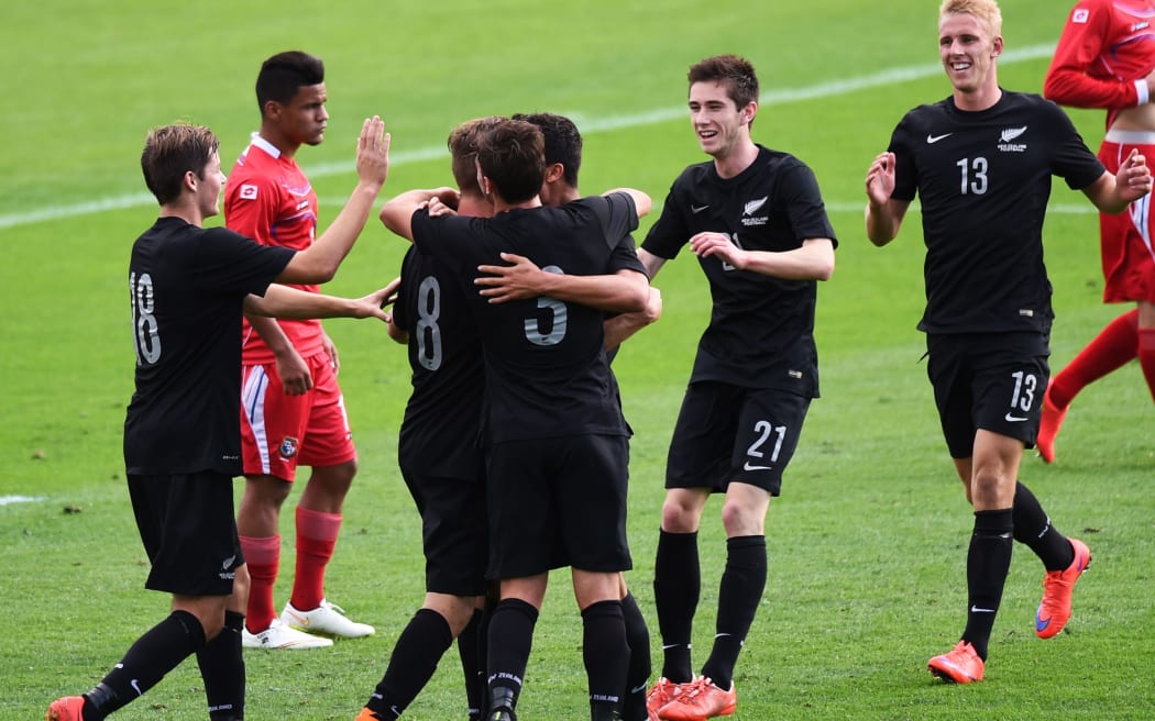 Matthew Ridenton celebrates his goal with his Junior All Whites team-mates
