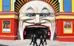 Police patrol at Luna Park in Melbourne on 25 September during an anti-lockdown rally.