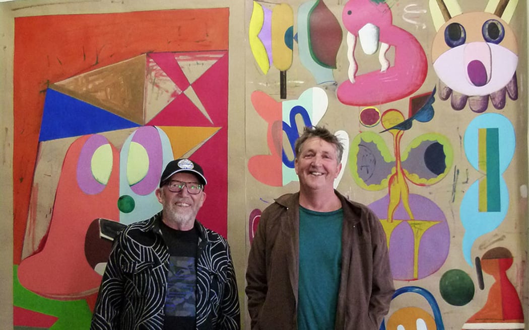 Artist Mark Braunias, right, in front of one of his paintings with art collector Chris Parkin.