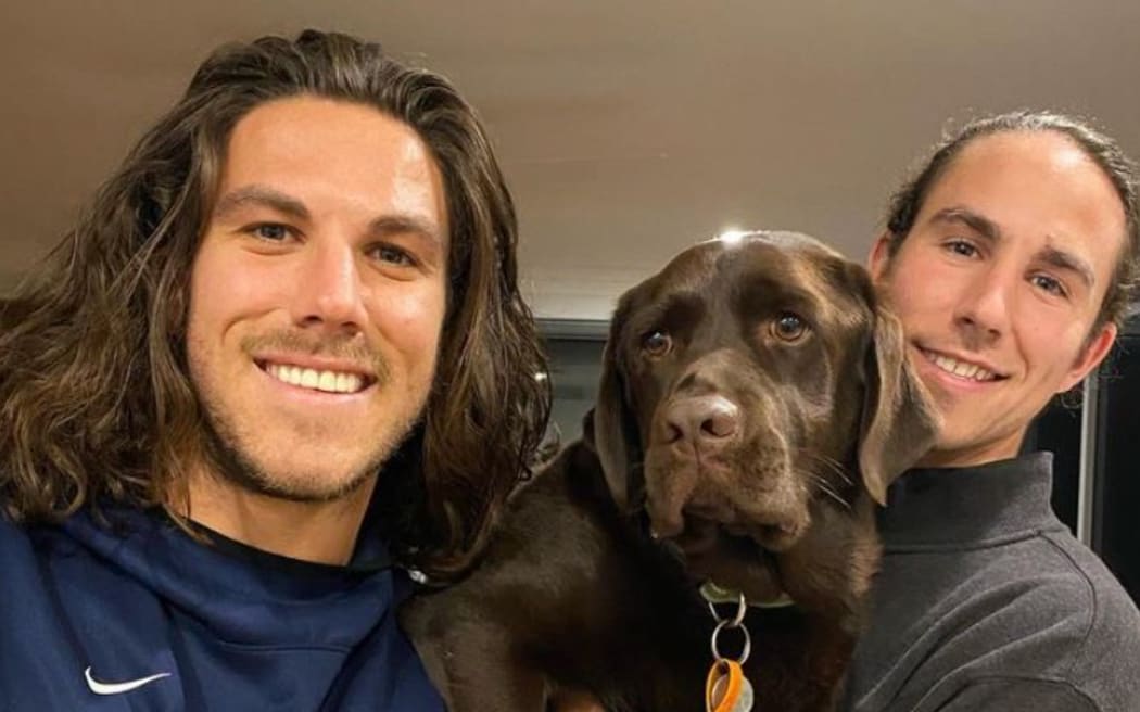 Callum, left, and Jake Robinson with their family dog.