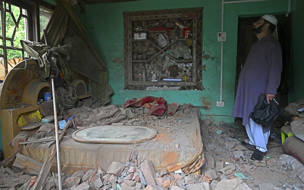 A local resident inspects his house that was damaged by Pakistani artillery shelling in Uri, about 100kms from Srinagar, on May 9, 2025. India said on May 9 it had repulsed a wave of Pakistani drone and artillery attacks overnight, and Islamabad insisted it had not struck targets across the border, as the latest conflict between the nuclear-armed neighbours showed no signs of relenting. (Photo by Tauseef MUSTAFA / AFP)