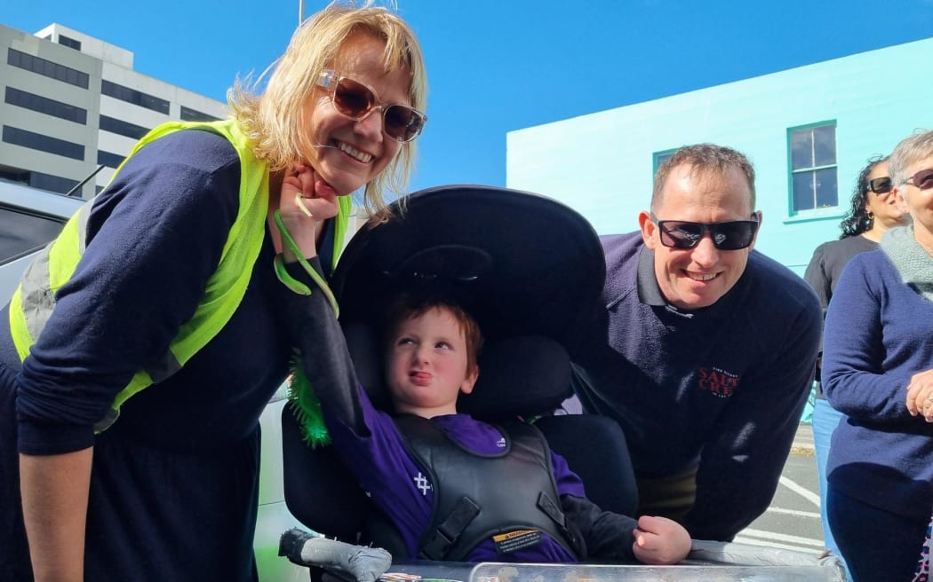 Protest co-organiser Francine Jones of Taranaki Disabilty Action with son Nash, who lives with Lesch-Nyhan Syndrome and dad.