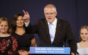Australian Prime Minister Scott Morrison speaks to party supporters flanked by his wife, Jenny, second left, and daughters Lily, right, and Abbey, after his opponent conceded in the federal election in Sydney, Australia.