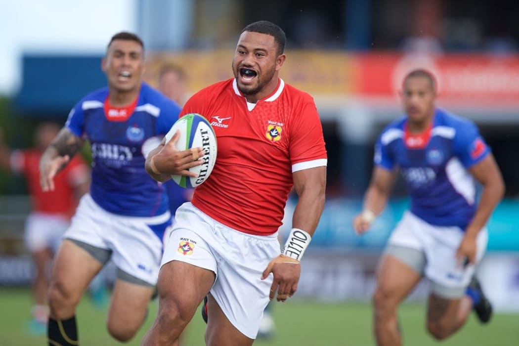 Tonga's Penikolo Latu races away to score Tonga's third try.