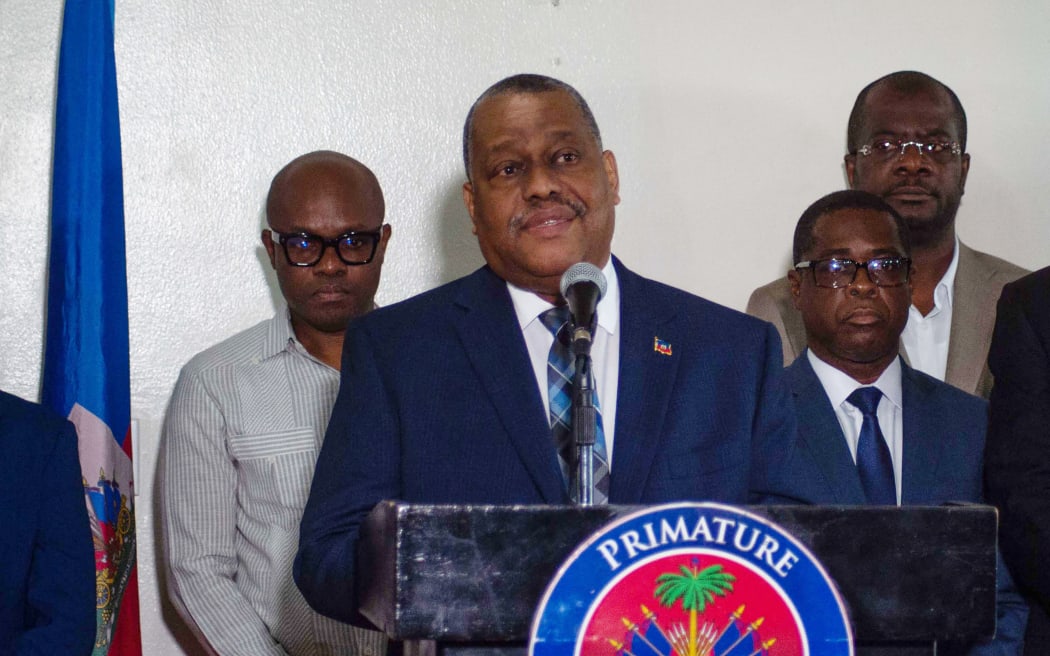 Haiti's Prime Minister Garry Conille speaks to the press on his return to Port-au-Prince, July 6, 2024, after travelling to the US and meeting with the UN Security Council. (Photo by Clarens SIFFROY / AFP)