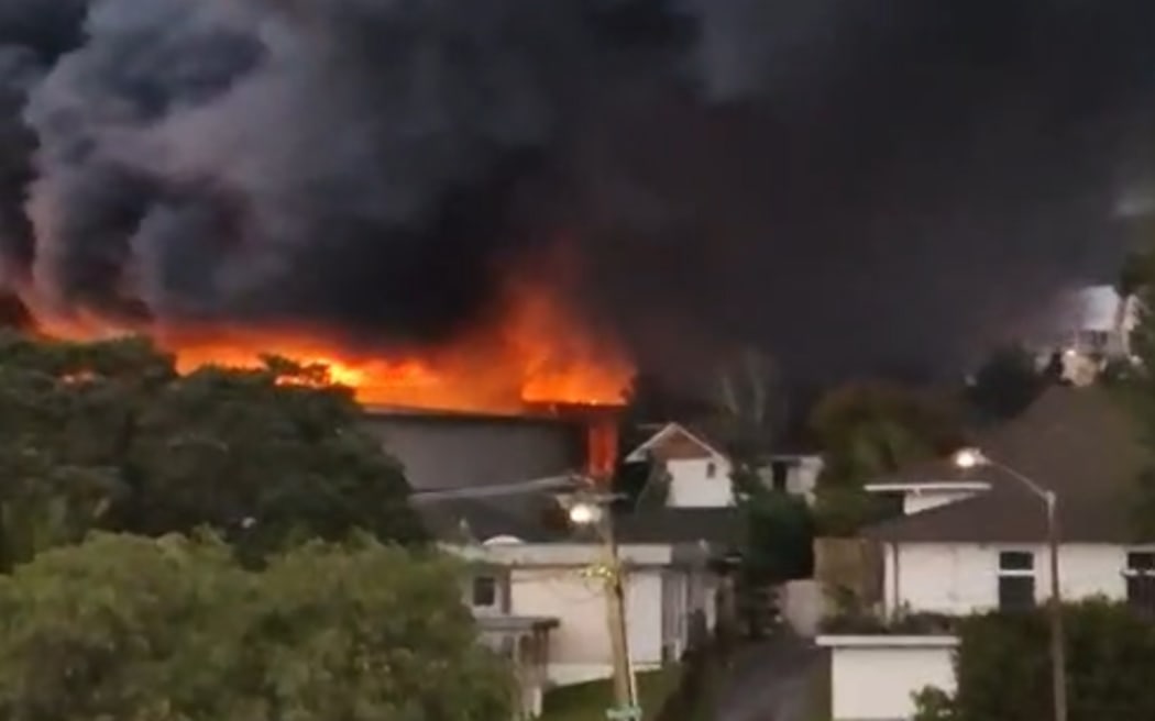 A screenshot from a video shows huge flames from the fire in Auckland's Wairau Valley.