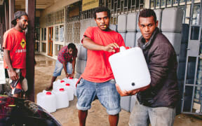 Local World Vision staff preparing aid items for distribution.