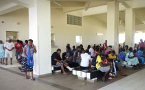 People wait to be seen at the main hospital in Port Vila after Cyclone Pam. One wing was left standing.