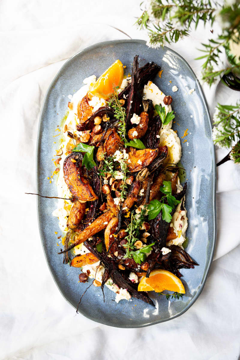 An oval platter containing Roast Butternut and Beet Salad With Orange Whipped Feta and Hazelnuts.