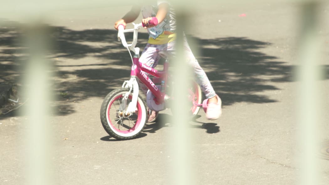 A child on a bike at an emergency accommodation motel.