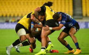 Rieko Ioane of the Blues is tackled.