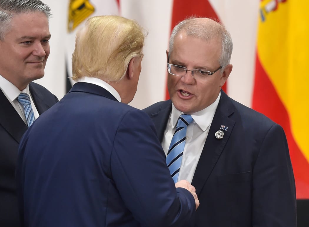 Australia's PM Scott Morrison greets Donald Trump at the G20 meeting in Osaka. Back home, Australia's economy is in trouble.
