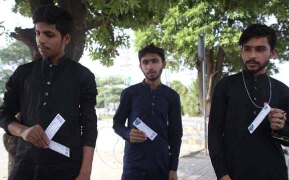 RAWALPINDI, PAKISTAN, SEPTEMBER 17: Pakistani spectators show tickets following the cancellation of cricket series between Pakistan and New Zealand, in Rawalpindi, Pakistan, on September 17, 2021.
