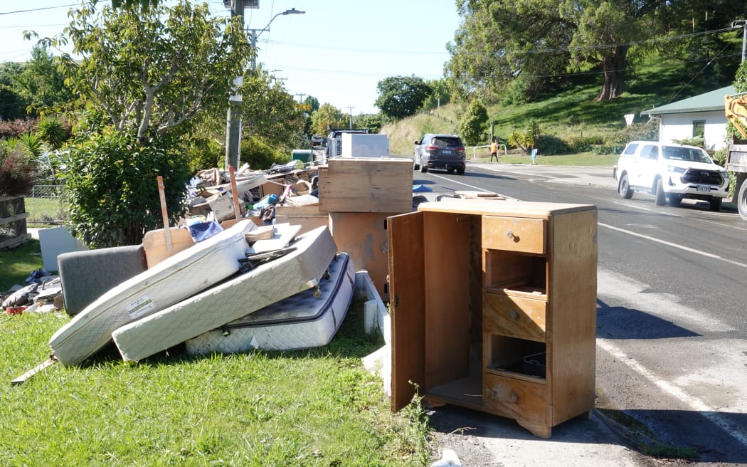 Damaged household items are piling up on Puketapu roads, but volunteers are removing the rubbish.
