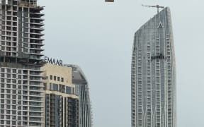 A picture taken with a mobile phone on March 12, shows a damaged building in the vicinity of Dubai Creek Harbour after a drone fell on it.