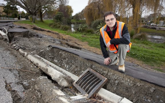 Misko Cubrinovski, from the University of Canterbury's School of Engineering, studies liquefaction and lateral spreading on Oxford Terrace, after the 2011 Christchurch earthquake.