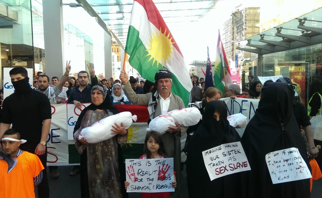 Members of New Zealand's Kurdish community take to the streets of Auckland to demand more humanitarian support and weaponry to fight Islamic State