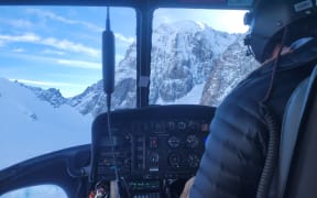 Department of Conservation Search and Rescue & The Helicopter Line undertaking search and rescue operations, looking toward the South face of Mt Hicks.