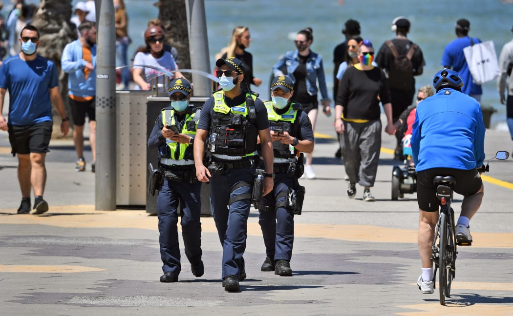 Protective Services Officers patrol along Melbourne's St Kilda Beach on 8 November, 2020 as Victoria's state government announces an easing of restrictions with no new cases of Covid-19 recorded for the ninth day in a row.