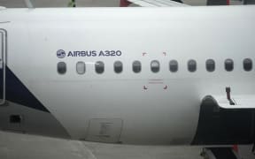 A Latam Airlines Airbus A320 sits on the tarmac at El Dorado airport in Bogota on28 November, 2025.