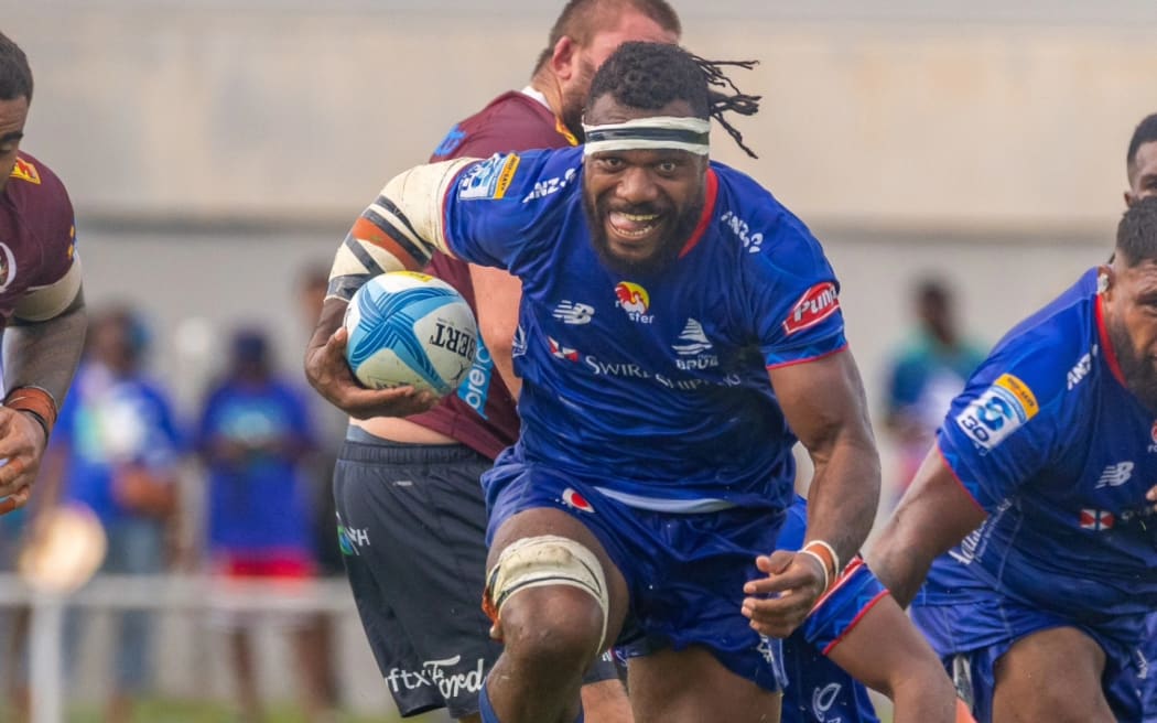 Fijian Drua No.8 Elia Canakaivata attacks against the Reds at Churchill Park.