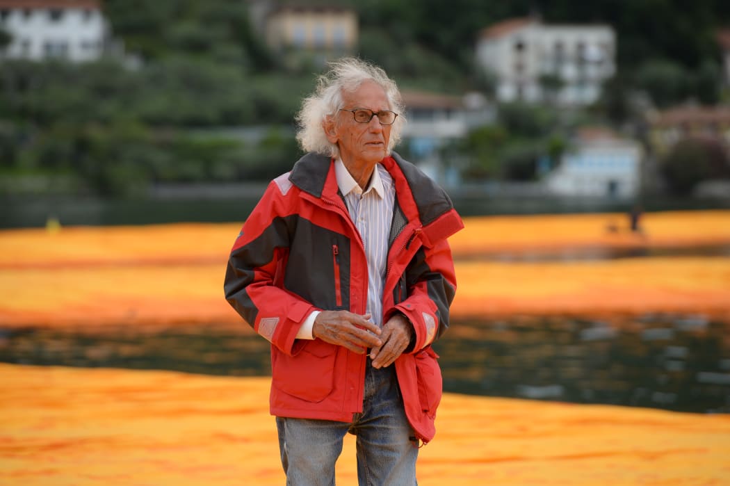 Artist Christo Vladimirov Javacheff walks on his monumental installation "The Floating Piers" he created with Jeanne-Claude at the lake Iseo, northern Italy, on June 16, 2016.