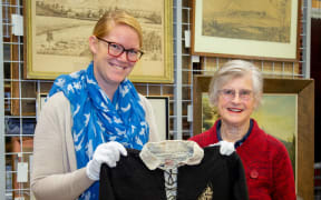 Puke Ariki social history curator Megan Wells and Vivienne Brown with Handley Brown’s All Blacks jersey from the Invincibles tour.