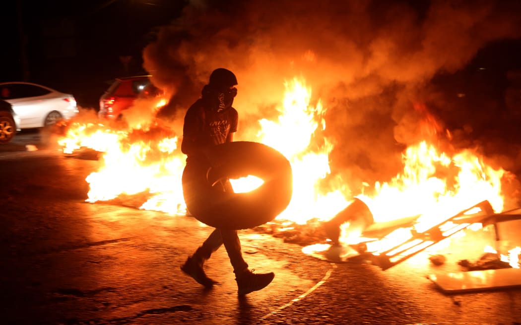 Palestinians set tyres on fire at the Huwwara checkpoint in Nablus, West Bank, on 7 August, 2022, to protest the Israeli air strikes on Gaza.